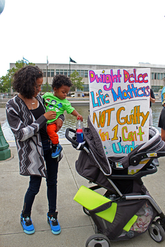 Protester Miranda Werntz and her son, Rockim, prepare their stroller with signs before the Black Lives Matter march on Monday afternoon.