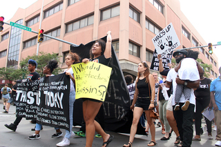 Protesters held signs with themes of police brutality and violence during the Black Lives Matter march.