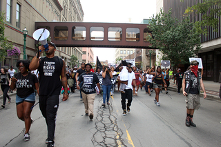 Hundreds of community members march down the streets of Syracuse to protest against police brutality.