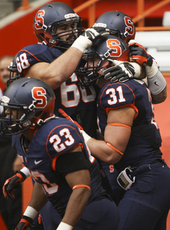 Syracuse fullback Clay Cleveland (31) celebrates with his teammates, including running back Prince-Tyson Gulley (23) and guard Nick Robinson (68).