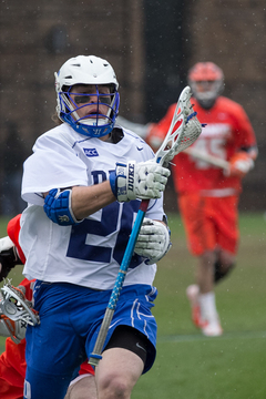 Duke midfielder Charlie Payton charges with the ball as a Syracuse defender tries to strip it from him. 