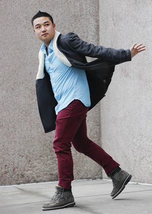 Leo wong, senior advertising major wears fleece-lined H&M gray coat on top of a turquoise button down, clashing with a pair of maroon pants during a gray day. He describes his style as preppy and professional. 