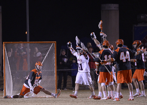 Dominic Lamolinara (left) looks on in a split position as Virginia celebrates a goal in its 17-12 win over the Orange. 