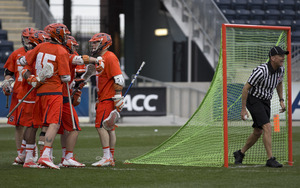 The Syracuse offense celebrates behind the Duke goal after a goal in the Orange's 16-15 win over the Blue Devils. 