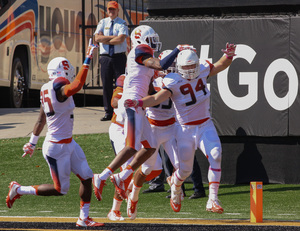 Robert Welsh celebrates with teammates after intercepting a pass and running in it in for a 42-yard touchdown. 