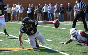 Wake Forest quarterback Tyler Cameron hits the ground on a sack by Syracuse defensive end Donnie Simmons. The Orange snapped a four-game losing streak Sunday, albeit against an inferior opponent. 