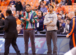 SU forward Michael Gbinije (right) looks on with injured forward DaJuan Coleman (left). Gbinije sat out the Orange's victory on Friday night for a reason head coach Jim Boeheim didn't disclose.