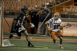 Dylan Donahue comes around from behind the net against an Army defender. He scored five goals Sunday and has developed into SU's top goal scorer with Kevin Rice the primary target of opponents defenses. 