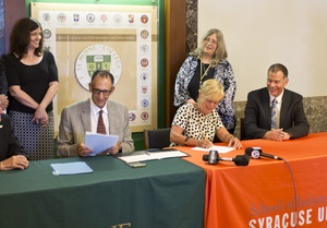 Kate Costello-Sullivan, Dean of the College of Arts & Sciences at Le Moyne; Thomas Brockelman, Interim Provost at Le Moyne; Liz Liddy, Interim Vice Chancellor and Provost at SU; Mary Collins, Associate Provost at Le Moyne; and Jeff Stanton, Interim Dean at the iSchool gather to make the partnership between the two schools official.