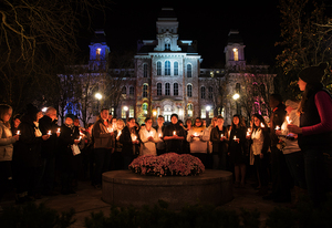 Students observe a moment of silence during a candlelight vigil hosted by Syracuse University’s Remembrance Scholars at the Remembrance Wall. More than 120 people were killed and over 350 wounded during coordinated terrorist attacks across Paris, Nov. 13.