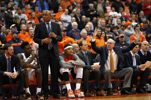 Dajuan Coleman sits on the bench next to assistant head coach Mike Hopkins. He started at center but played just five minutes in Syracuse's first loss of the season.