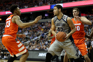 Syracuse players surround Georgetown's Bradley Hayes. The Orange suffered its second loss of the season on Saturday.