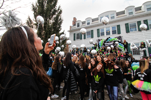 The Alpha Phi Sorority welcomes new members outside of its house on Walnut Place.