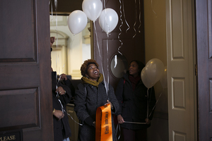 (From left) Gerald Brown and Nina Rodgers walk outside of Hendricks Chapel to tie balloons and ribbons to a tree as a part of the Martin Luther King, Jr. remembrance ceremony.