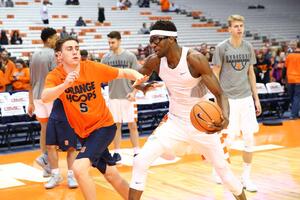 Student manager CB Garrett guards center Paschal Chukwu during pregame warmups.