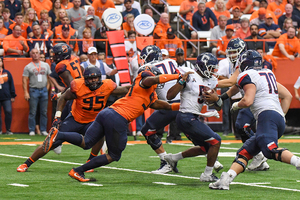 Alton Robinson, pictured grabbing UConn's quarterback, racked up three of the six Syracuse sacks on Saturday.