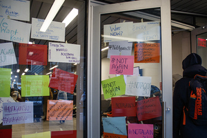 An entrance to the Barnes Center remains covered with messages from students, many with #NotAgainSU. 