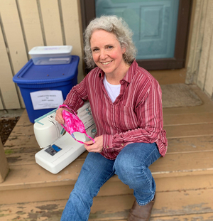 Nancy Gaus, the creator of The Syracuse Mask Project, sits with the sewing machine she uses to make masks for coronavirus first responders in the community.