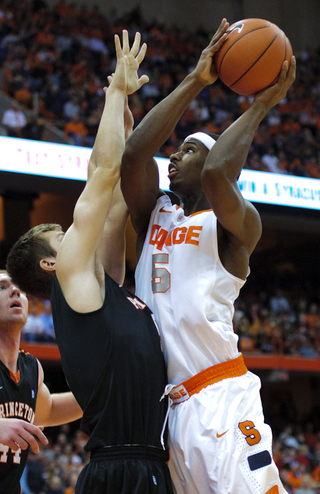 Syracuse forward C.J. Fair leans in to attempt a shot.