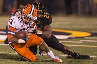 Syracuse running back Prince-Tyson Gulley gets brought down by linebacker Zaviar Gooden.