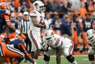 Louisville quarterback Teddy Bridgewater steps away from the line to call a timeout.