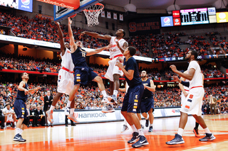 Syracuse forward Rakeem Christmas fights for a rebound with Canisius guard Billy Baron in the Orange's 85-61 win over the Golden Griffins. 