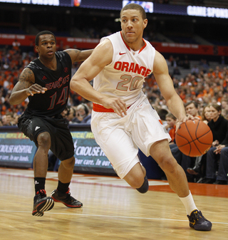 Syracuse guard Brandon Triche drives the baseline as he is defended by Cincinnati guard Ge'Lawn Guy.