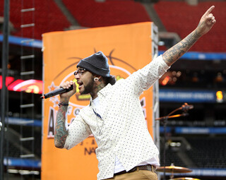 Lead singer Travis McCoy of Gym Class Heroes performs before the All Star Game during the Final Four 2013 NCAA Men's Basketball Tournament.