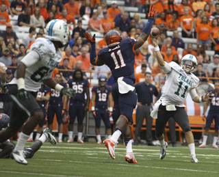 Syracuse linebacker Marquis Spruill attempts to bat down a pass by Tulane quarterback Nick Montana.