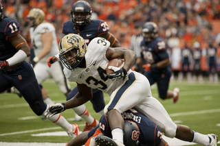 Eskridge and the Orange's defense trip up Panther running back Isaac Bennet as he tries to break a run.