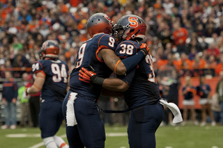 Lynch and Orange cornerback Ri'Shard Anderson embrace.