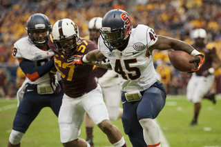 Jerome Smith stiff arms a defender while bouncing outside. 