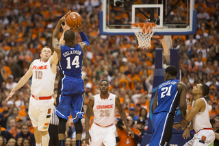 Sulaimon shoots a 3-pointer over Cooney's outstretched arm.