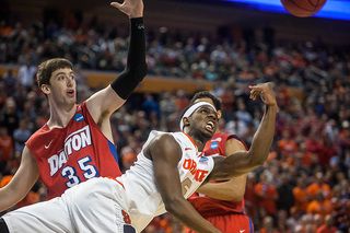 Fair flips a shot toward the rim after squeezing by Dayton center Matt Kavanaugh. 