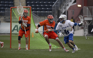 Dominic Lamolinara awaits a Duke shot from the Syracuse net.