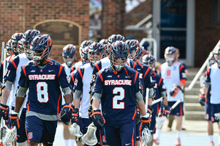 Seniors Kevin Rice and Hakeem Lecky lead the Orange out to the field.