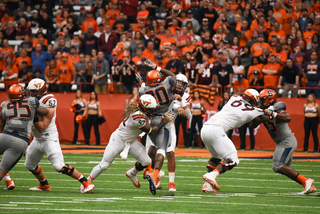 SU linebacker Parris Bennett leaps to block a Jerod Evans pass. The Orange shut down an offense that had looked solid in weeks past, especially in a 34-3 win over North Carolina. 