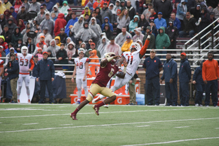 Syracuse cornerback Corey Winfield (11) extends his left arm to make a play on the ball.