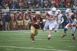 Syracuse's Jonathan Thomas (23) and Matt Keller (47) track down BC's Tyler Rouse.