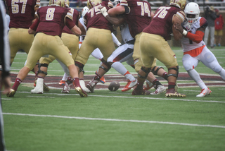 The football drops to the turf as both teams jostle for position.