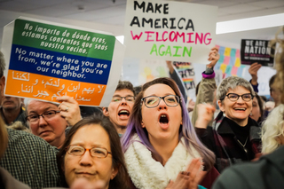 Protesters cheer as Syracuse Mayor Stephanie Miner gives a speech.