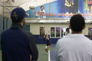 Syracuse coaches watch on as the Orange play in the match.