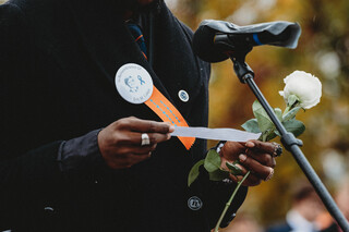 Scholar Cleo Hamilton reads his passage in honor of Eric Coker.