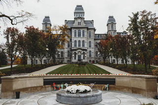 The roses of the Remembrance Scholars lay on top of the Remembrance Wall.