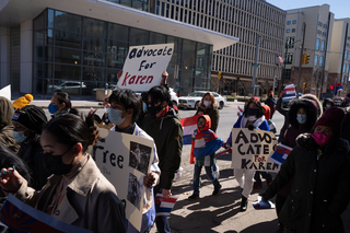 Community members march through the streets of Syracuse to raise awareness of human rights violations against the Karen people.