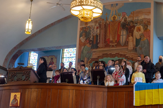 Members of the congregation sing in prayer at the service offered for Ukraine. 